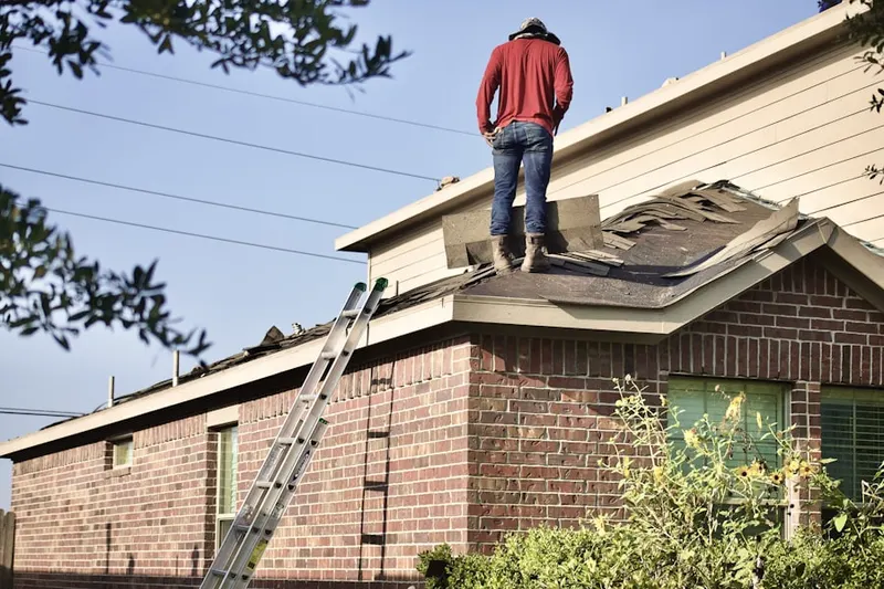 Professional roofer working on a residential roof in Clayton